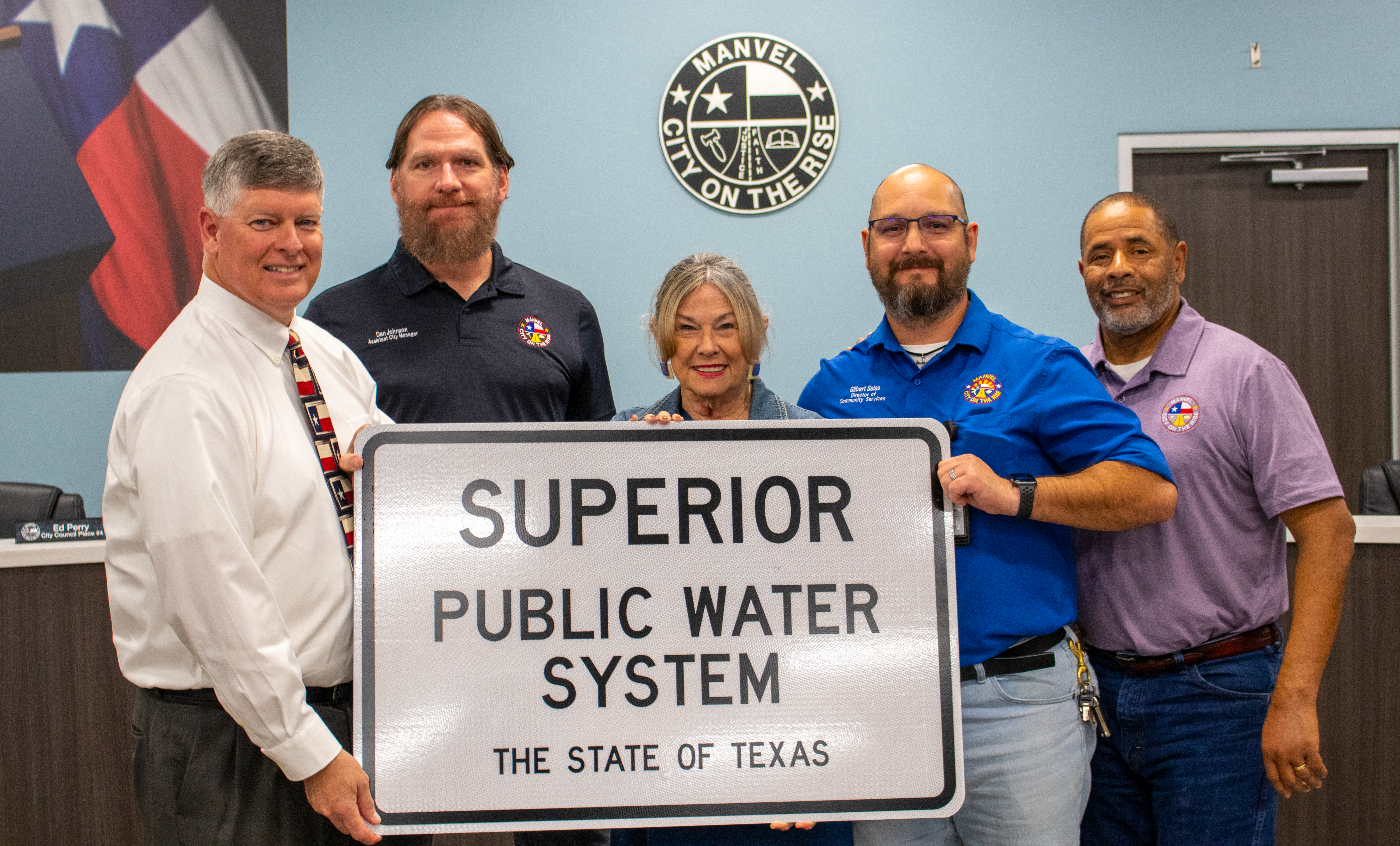 Photo in Council Chambers of Mayor Davison, Jung, Johnson, Salas, & Word holding Superior Water sign